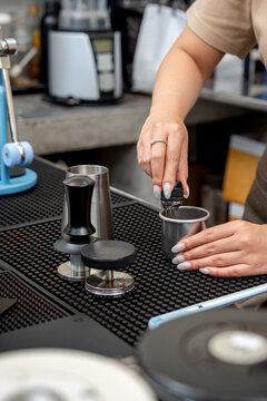 Hands performing the Weiss Distribution Technique with a WDT tool at a coffee station.