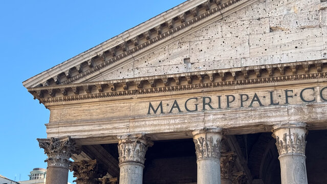Close-up of weathered carved Roman lettering on the Pantheon frieze, Rome, Italy