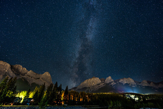 Milky Way galaxy arching high over Canadian Rockies mountain range. Canmore, Alberta, Canada.