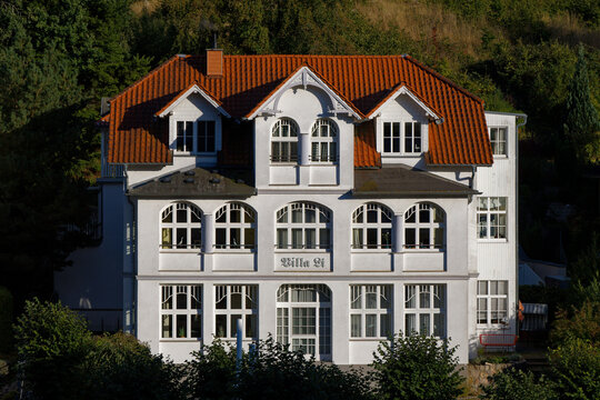 Elegant Historic White Villa with Red Tiled Roof in German Resort Architecture Style