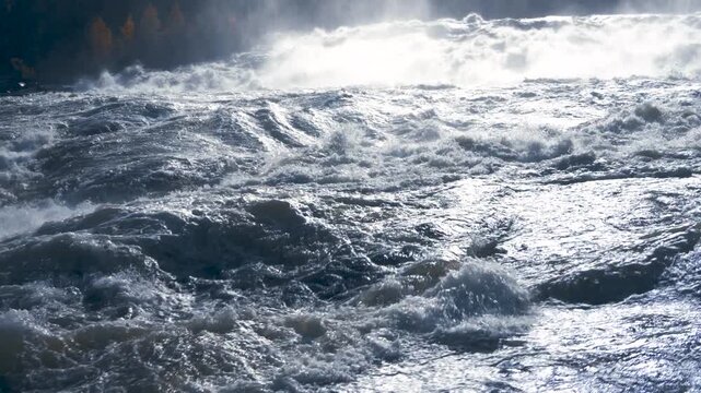 Majestic Storforsen waterfall creating a powerful and misty spectacle in the wilderness of Sweden, a beautiful example of the untamed force of nature in a Scandinavian landscape