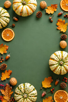 Autumn Harvest Border with Pumpkins and Leaves on Green Background