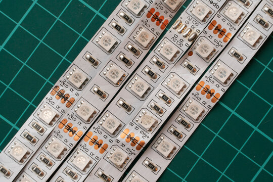 Close up view of flexible rgb led light strips on a green cutting mat for electronic repair or diy project