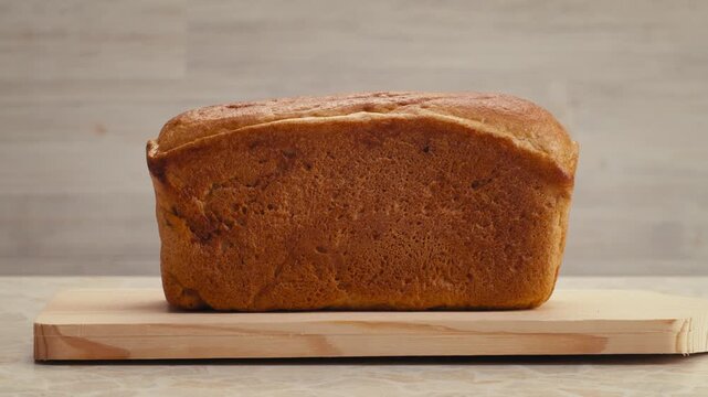 Black rye bread close up, dark brown sliced loaf, borodinsky slavic food, square slices with coriander on white background