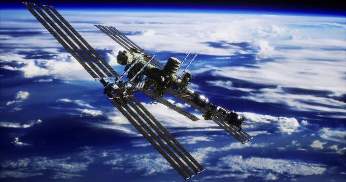 The International Space Station floats gracefully above Earth, showcasing its intricate structure and solar panels. Wisps of clouds glide beneath the station in the vastness of space.