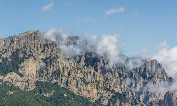 Cliffs and rocks in front of clouds, Col de Bavella Bavella Massif, Corsica, France