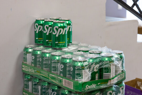 Green Sprite lemon-lime soda cans stacked in plastic-wrapped multipacks with several loose cans on top inside store. Kaliningrad, Kaliningrad Region. October 7, 2026