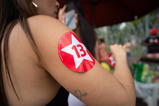 Red political sticker with a star and a number on an arm