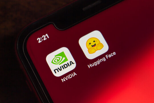 Quetzaltenango, GUATEMALA - Sep 9 2026 : NVIDIA and Hugging Face App Icons on iPhone Home Screen, Red Wallpaper