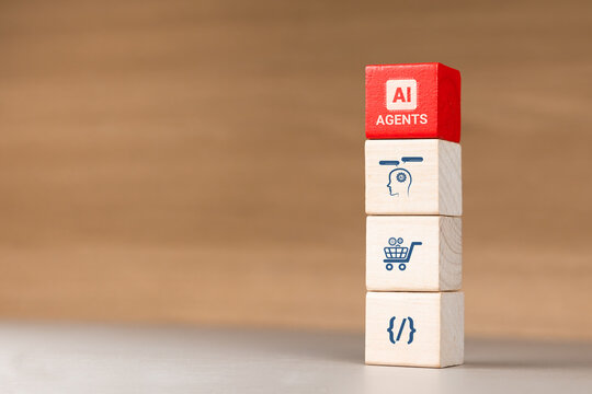 Stacked wooden blocks with business and technology icons, red AI AGENTS cube on top. Concept of AI agents, automation of specific tasks, and business innovation.