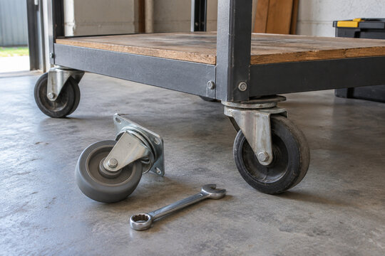 Spare caster wheel beside a workshop trolley