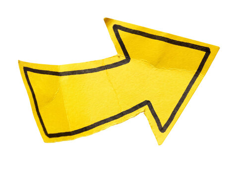 Hand drawn yellow paper arrow cut out isolated on a white background.