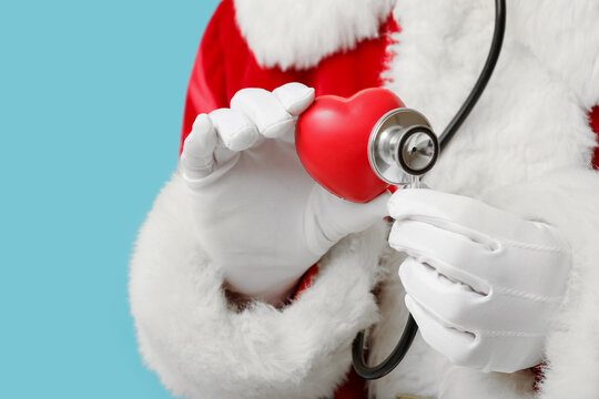 Holiday healthcare and medical checkup, Santa Claus holding a red heart and stethoscope for winter wellness and seasonal health insurance awareness