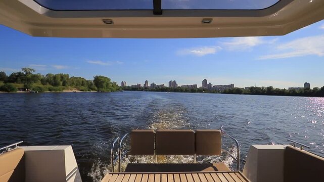 Motorboat wake with city skyline view