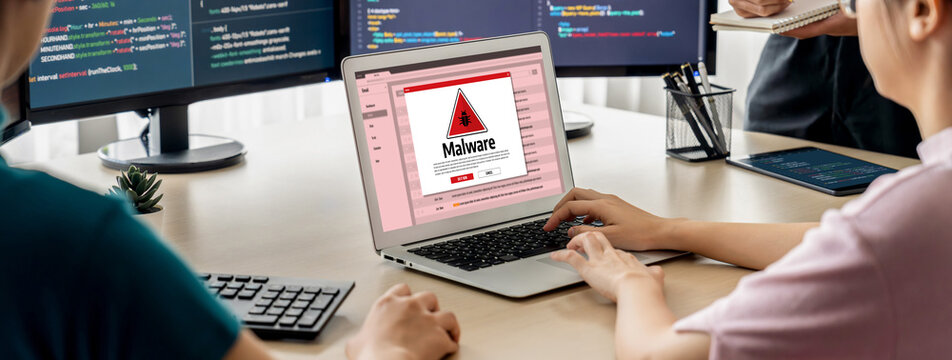 Cyber attacking concept. Malware alert showing on computer screen display scam and threat detection on computer system or online server to be removed brisk.