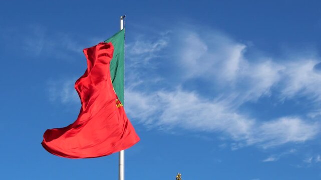 Portugal flag blowing close to center flag pole
