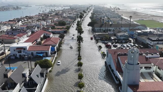 Aerial drone shot of coastal flooding on Balboa Blvd on peninsula in Newport Beach Orange County California following tropical storm Rachel.