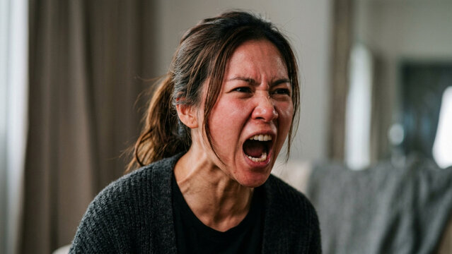 Stressed Woman Screaming and Feeling Angry at Home