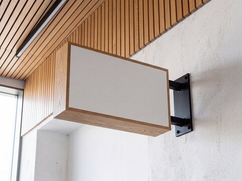 Blank wooden wall mounted shop sign mockup in modern interior