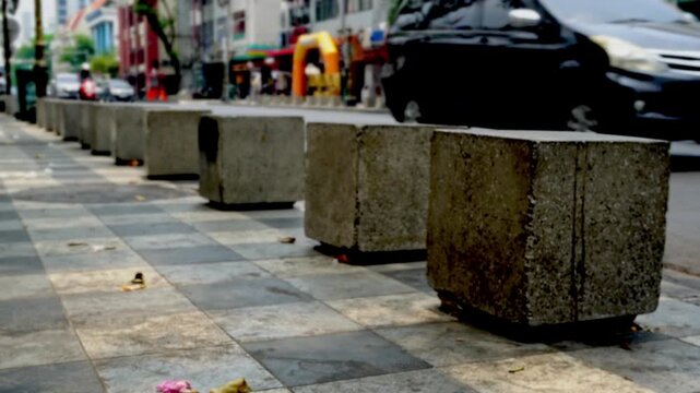 Concrete Traffic Bollards Line A Sidewalk In The City