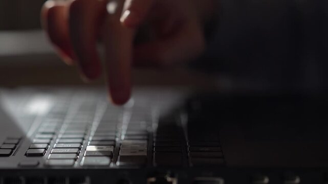 Unrecognizable hands of a teenager, closeup, are using a digital tablet computer. A teenager is lying on the sofa and using the computer.