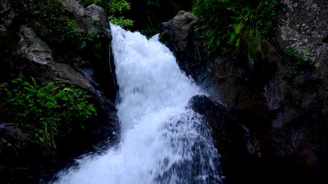 Closeup Tavoro waterfall with fast flowing water torrent in Bouma National Heritage Park on tropical island Taveuni Fiji