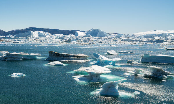 Climate Change and Global Warming - Icebergs and ice from melting glacier in icefjord in Ilulissat, Greenland. Aerial photo of arctic nature ice landscape.