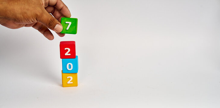 Hand stacking final digit to form 2027