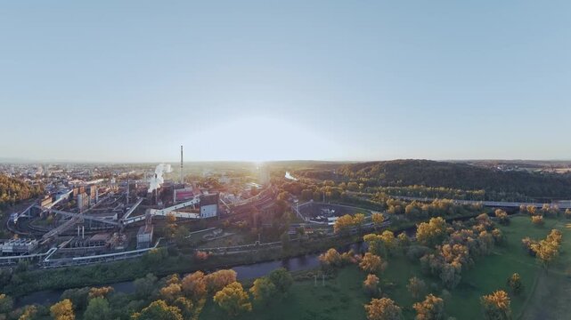 Elevated drone view reveals the Koksovna industrial coking plant as the sun rises over Ostrava, suitable for manufacturing, heavy industry and regional development content.