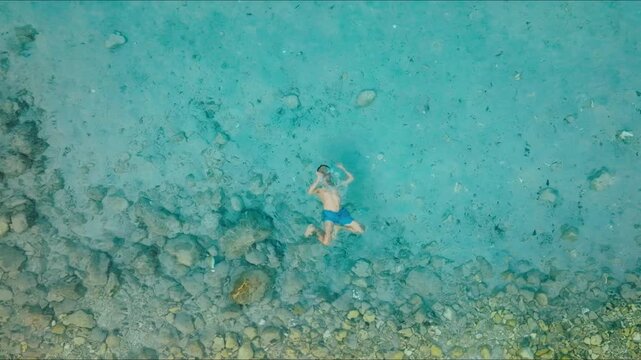 Top down view of a man swimming in crystal clear turquoise sea in Hvar, Croatia, Part 2
