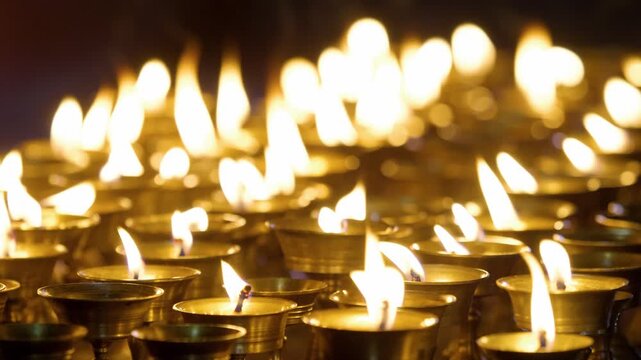 Close-up of lit candles at a Buddhist monastery &ndash; Buddhist religious tradition