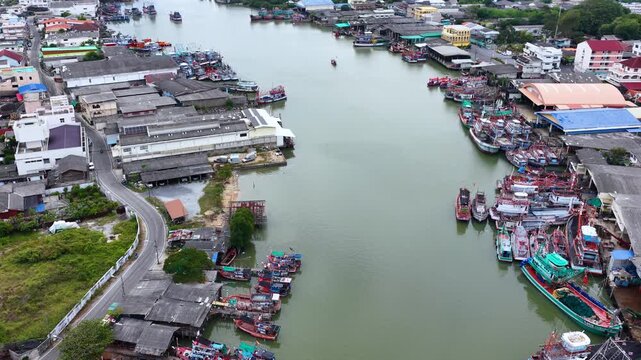 Aerial View of Fishing Boats Docked Along a River Canal in Thailand