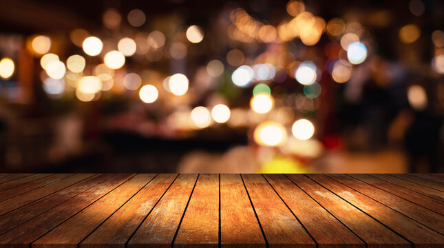 A empty wooden table  in a restuarant blurred background
