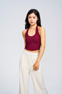 Asian model in burgundy halter tank top and white wide-leg pants