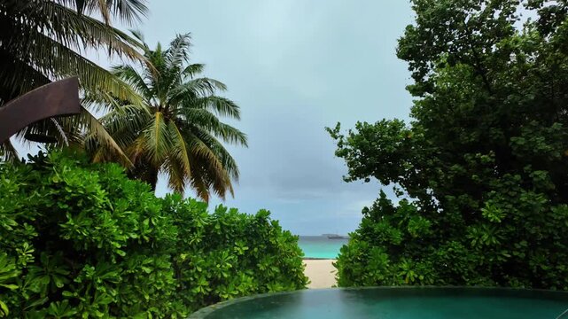 Timelapse of an overcast infinity pool with tropical plants in the Maldives