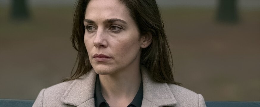 Captures Close Of Woman Seated Outdoors Contemplative With Slight Frown Gaze Directed To Side Suggesting Deep Thought Concern Hair