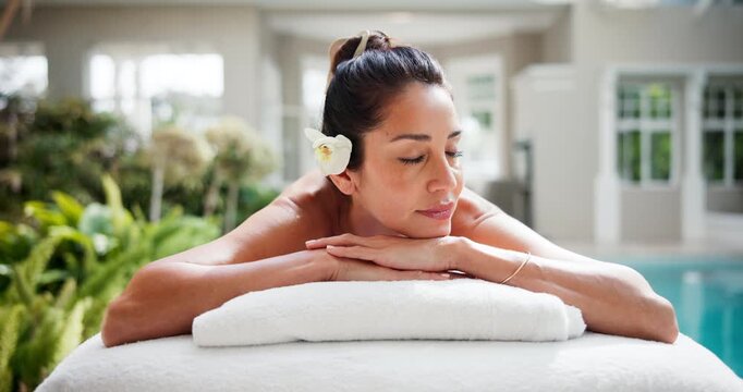 Woman, sleeping and relax in spa with peace, comfort and rest on towel for stress relief at resort. Smile, client and mature person on wellness retreat for skincare, self care and bed at luxury hotel