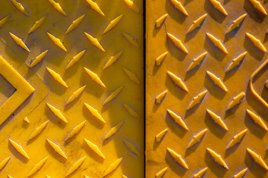 Yellow diamond plate textured plastic surface background