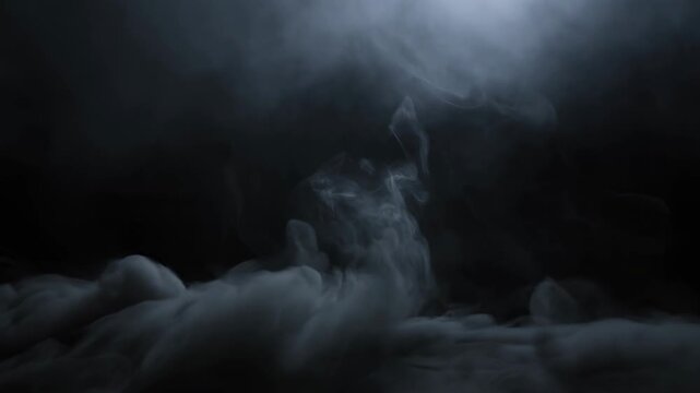 Dark smoke swirls through a nearly black atmospheric field with rising vapor wisps. Horror title sequences, cinematic intros, and fantasy trailers.