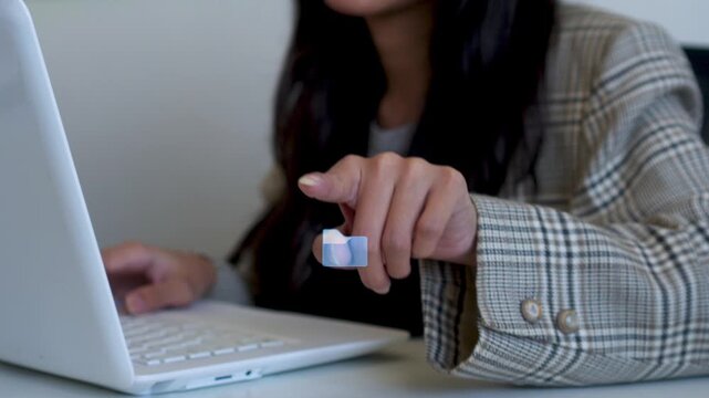 Close-up of Businesswoman hands typing on laptop with floating 3D folder graphic array