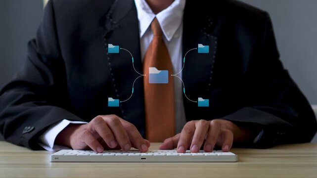 Close-up of businessman typing with animated data flow, folders, image, and video icons graphic