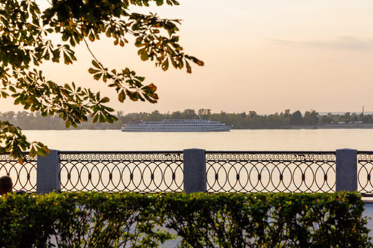 Riverside promenade with decorative railing at sunset