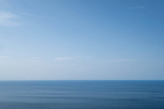 Clear blue sky above calm sea