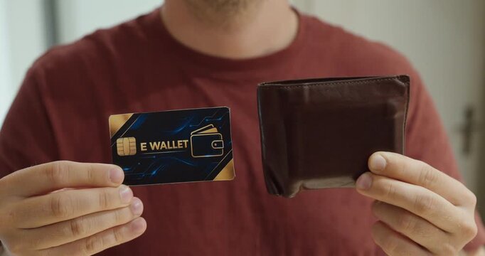 Man comparing an electronic wallet card with a traditional leather wallet. Concept for digital payments, cashless technology, fintech and modern banking.