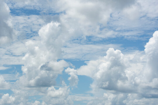 White puffy Cumulus clouds in blue sky