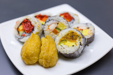 Japanese sushi roll set and inari sushi on white plate © leungchopan
