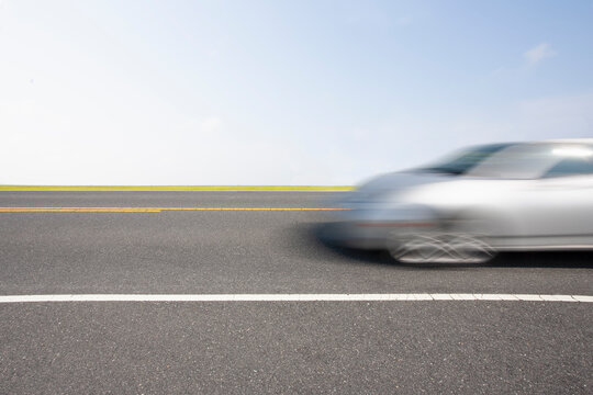 Silver sports car in motion