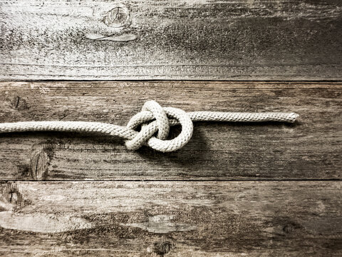 Bow line knot on wooden surface