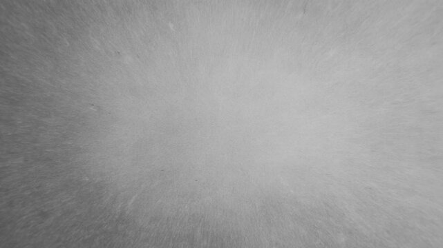 Gray radial texture softly flows across a monochrome field with a bright center and shaded edges. Title cards, website headers, and motion graphics.