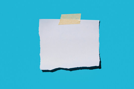Torn blank paper on blue background